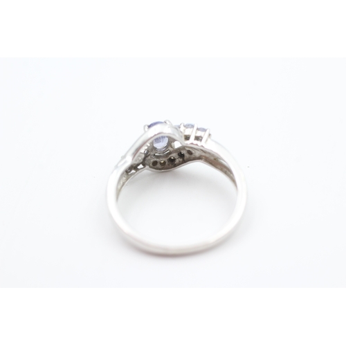 102 - 9ct white gold diamond accented tanzanite set dress ring (2.6g) Size  N