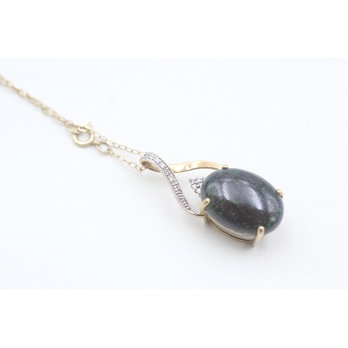 123 - 9ct gold diamond accented black opal cabochon set pendant necklace (2g)