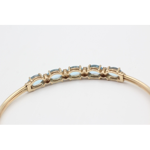 16 - 9ct gold diamond & topaz five stone bangle (6.8g)