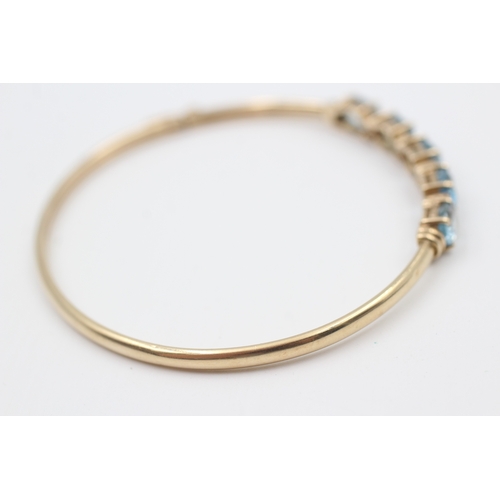 16 - 9ct gold diamond & topaz five stone bangle (6.8g)