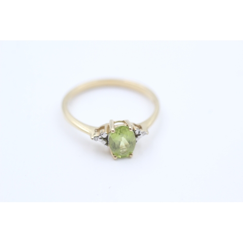 40 - 9ct gold diamond accented oval cut peridot set dress ring (1.7g) Size  Q