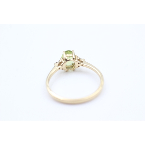 40 - 9ct gold diamond accented oval cut peridot set dress ring (1.7g) Size  Q