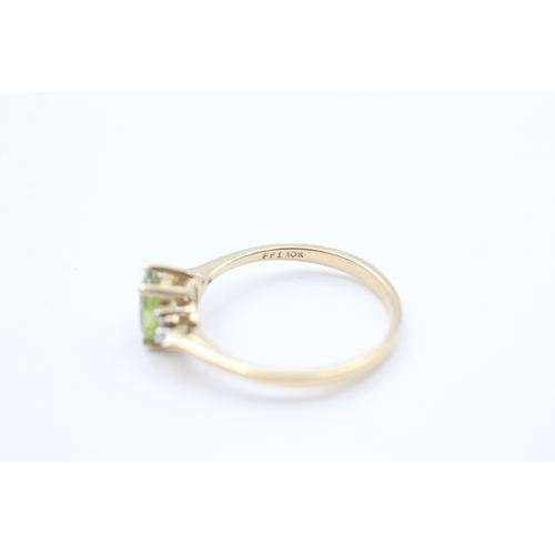 40 - 9ct gold diamond accented oval cut peridot set dress ring (1.7g) Size  Q