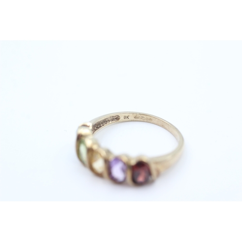 49 - 9ct gold garnet, amethyst, Citrine, peridot and blue topaz set five stone eternity ring (2.6g) Size ... 