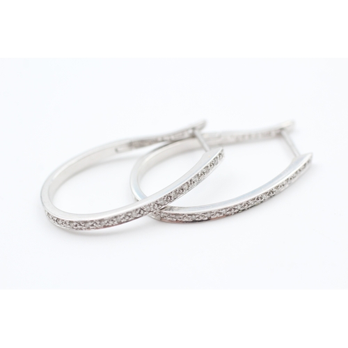 66 - 9ct white gold diamond full hoop earrings (3.3g)