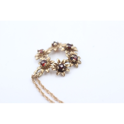 77 - 9ct gold garnet set floral wreath pendant necklace (3.6g)