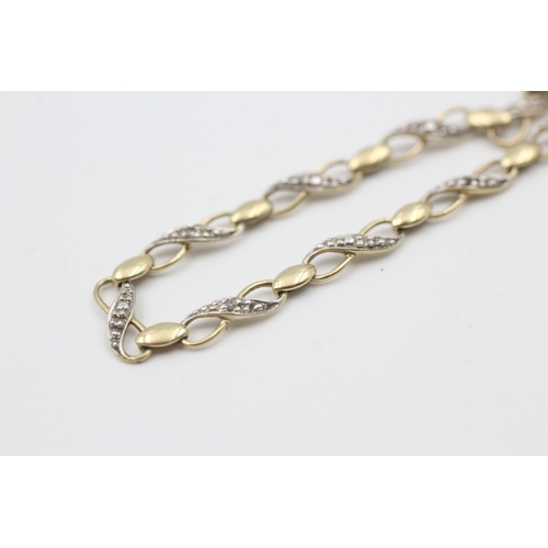 93 - 9ct gold diamond set figure of eight station bracelet (2.8g)