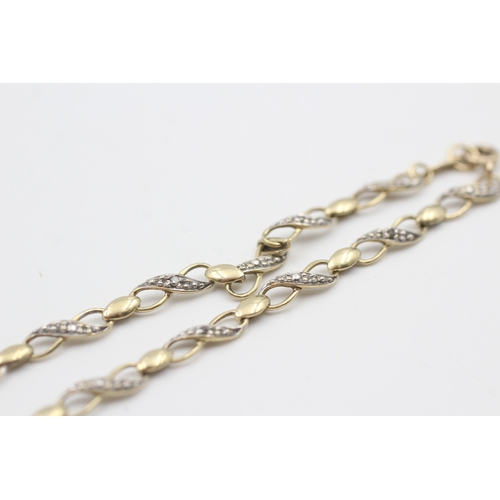 93 - 9ct gold diamond set figure of eight station bracelet (2.8g)