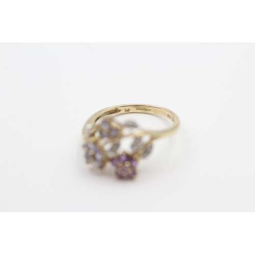 109 - 9ct gold tanzanite, diamond, and amethyst set floral garland ring (2.3g) Size  L