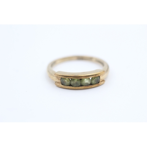 126 - 9ct gold channel set peridot four stone eternity ring (2.5g) Size  M