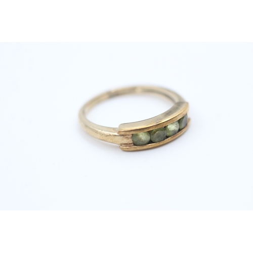 126 - 9ct gold channel set peridot four stone eternity ring (2.5g) Size  M