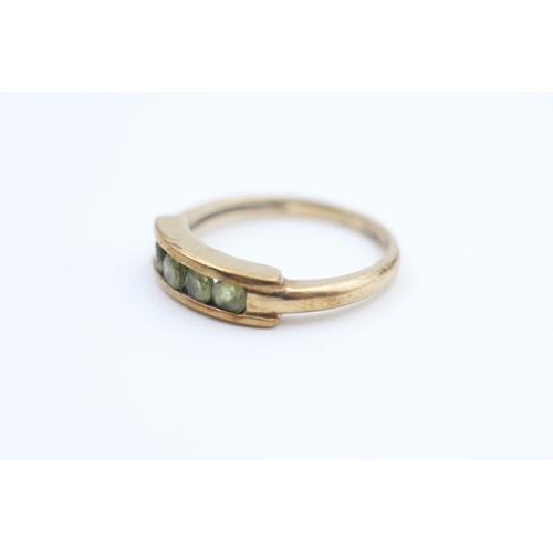 126 - 9ct gold channel set peridot four stone eternity ring (2.5g) Size  M