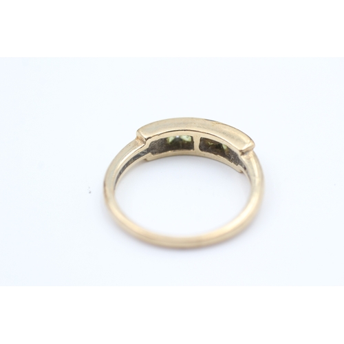 126 - 9ct gold channel set peridot four stone eternity ring (2.5g) Size  M