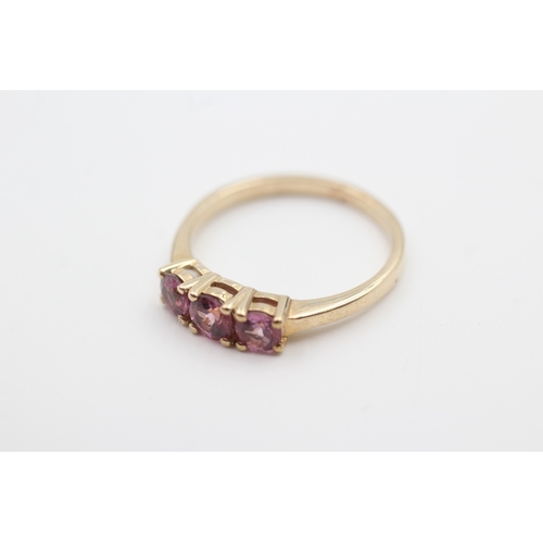 130 - 9ct gold pink garnet three stone ring (2.5g) Size  P 1/2