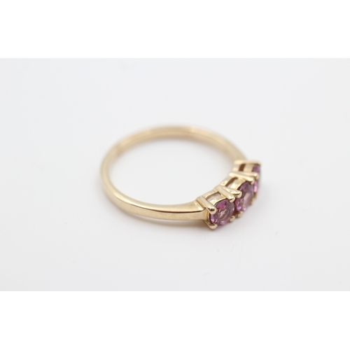 130 - 9ct gold pink garnet three stone ring (2.5g) Size  P 1/2