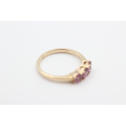 130 - 9ct gold pink garnet three stone ring (2.5g) Size  P 1/2