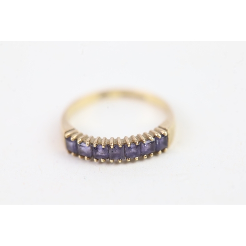 136 - 9ct gold square cut iolite set even stone eternity ring (1.4g) Size  K 1/2