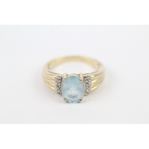 140 - 9ct gold diamond accented blue topaz set cocktail ring (3.2g) Size  M