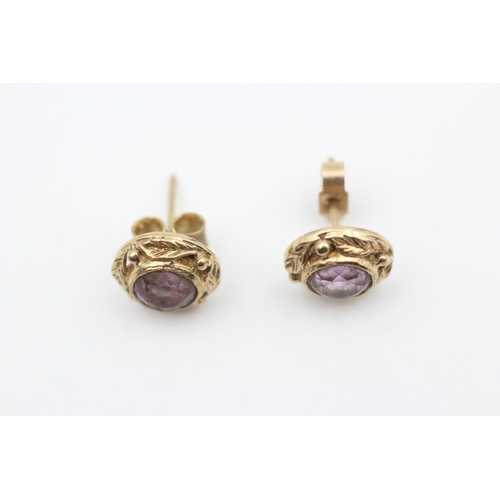 158 - 9ct gold foliate framed amethyst set stud earrings (2.4g)