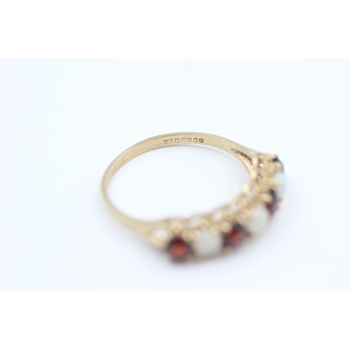 177 - 9ct gold opal and garnet set seven stone eternity ring (1.7g) Size  O