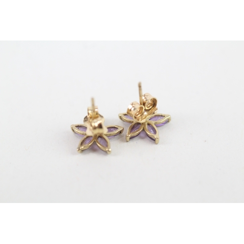 209 - 9ct gold amethyst set floral stud earrings (0.9g)