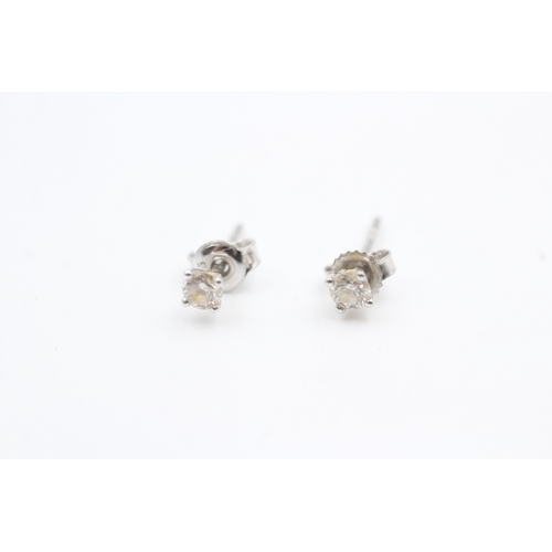 211 - 9ct white gold diamond set solitaire stud earrings (0.6g)