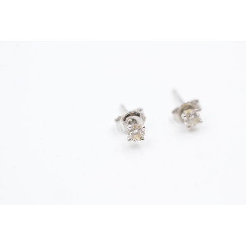 211 - 9ct white gold diamond set solitaire stud earrings (0.6g)