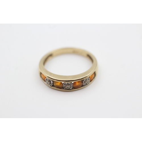 217 - 9ct gold diamond and orange gemstone seven stone eternity ring (2.3g) Size  O