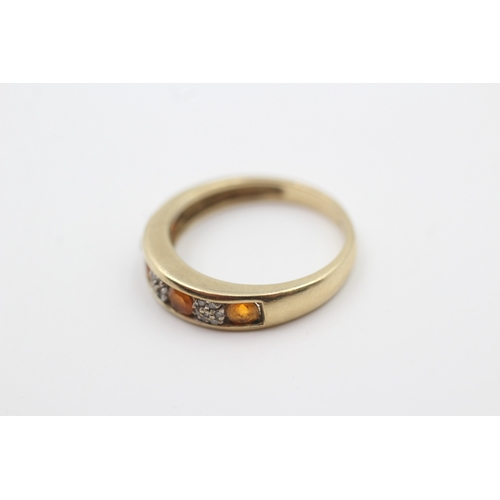 217 - 9ct gold diamond and orange gemstone seven stone eternity ring (2.3g) Size  O