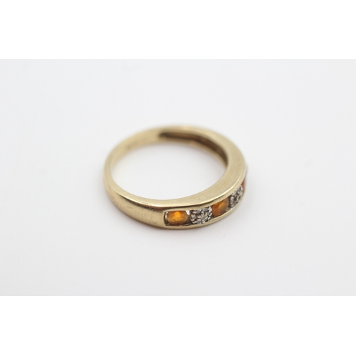 217 - 9ct gold diamond and orange gemstone seven stone eternity ring (2.3g) Size  O