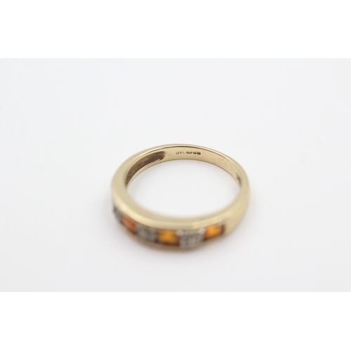 217 - 9ct gold diamond and orange gemstone seven stone eternity ring (2.3g) Size  O