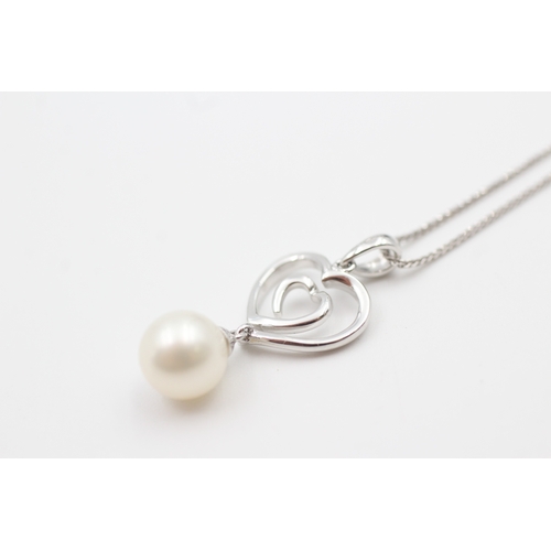 219 - 18ct white gold cultured pearl set open heart pendant necklace (3.1g)