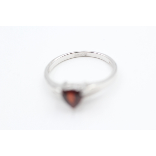 27 - 9ct white gold trilliant cut garnet set solitaire ring (2.3g) Size  N 1/2