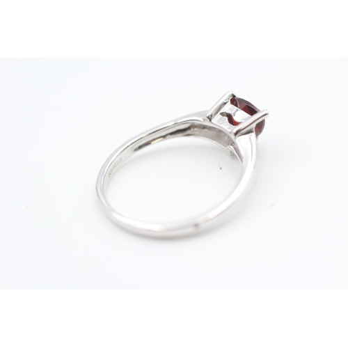 27 - 9ct white gold trilliant cut garnet set solitaire ring (2.3g) Size  N 1/2