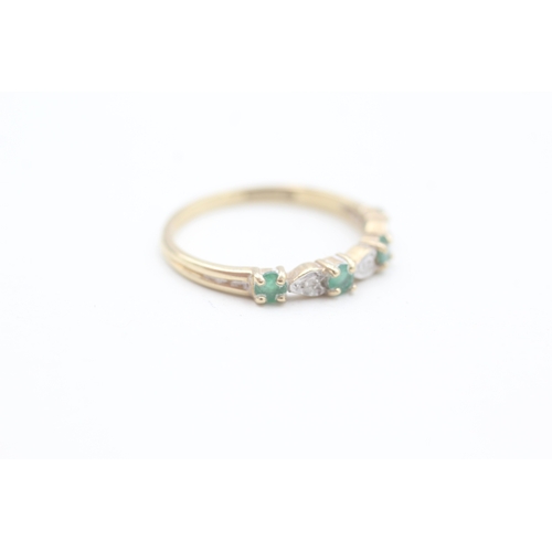 69 - 9ct gold diamond and emerald set seven stone eternity ring (1.5g) Size  P