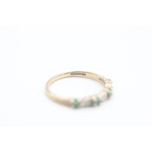 69 - 9ct gold diamond and emerald set seven stone eternity ring (1.5g) Size  P