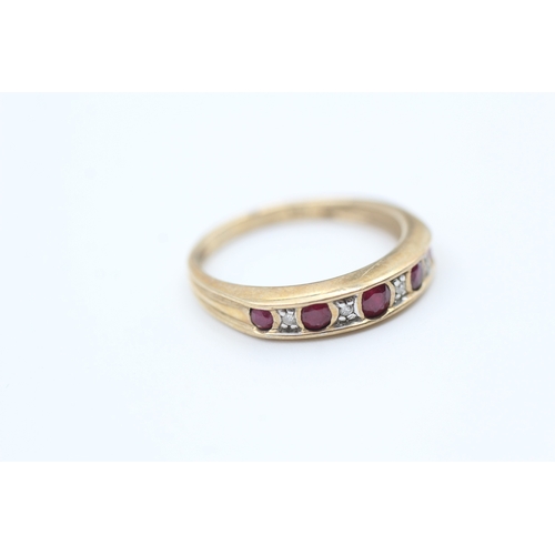 78 - 9ct gold diamond and ruby set nine stone eternity ring (2g) Size  N