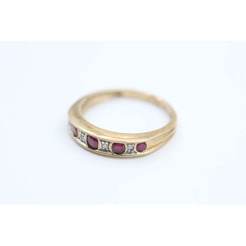 78 - 9ct gold diamond and ruby set nine stone eternity ring (2g) Size  N