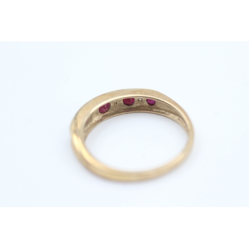 78 - 9ct gold diamond and ruby set nine stone eternity ring (2g) Size  N