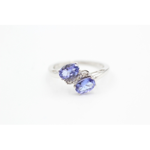 79 - 9ct white gold diamond and tanzanite bypass ring (1.8g) Size  K