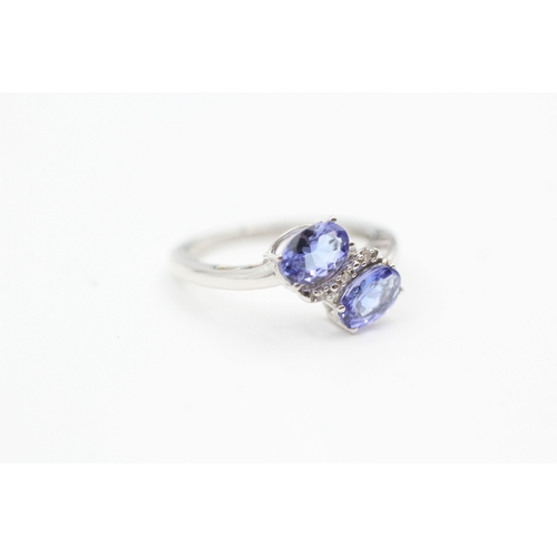 79 - 9ct white gold diamond and tanzanite bypass ring (1.8g) Size  K