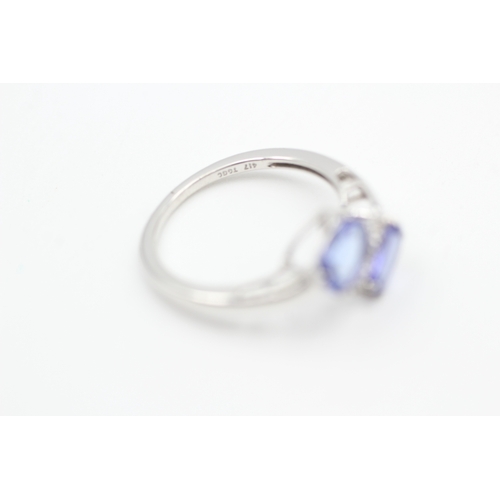 79 - 9ct white gold diamond and tanzanite bypass ring (1.8g) Size  K