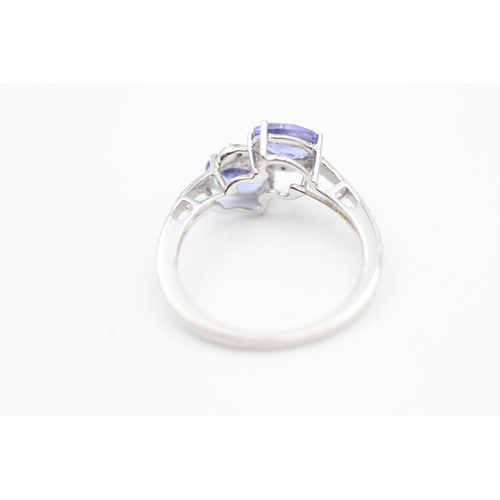 79 - 9ct white gold diamond and tanzanite bypass ring (1.8g) Size  K