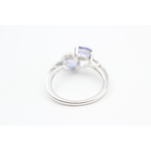 79 - 9ct white gold diamond and tanzanite bypass ring (1.8g) Size  K