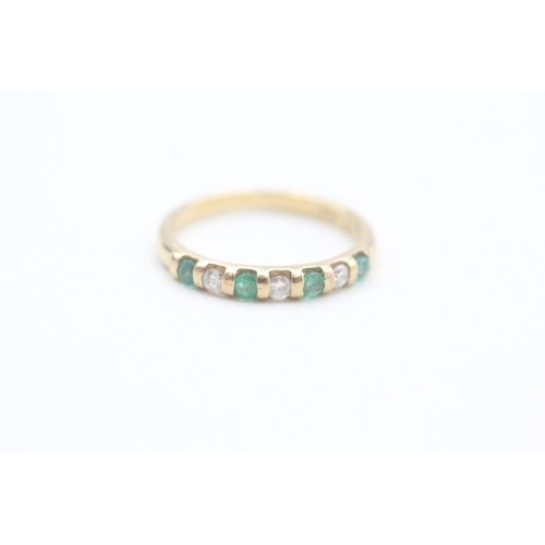 86 - 9ct gold diamond and emerald set seven stone eternity ring (1.6g) Size  L