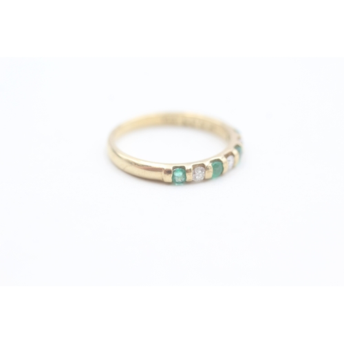 86 - 9ct gold diamond and emerald set seven stone eternity ring (1.6g) Size  L