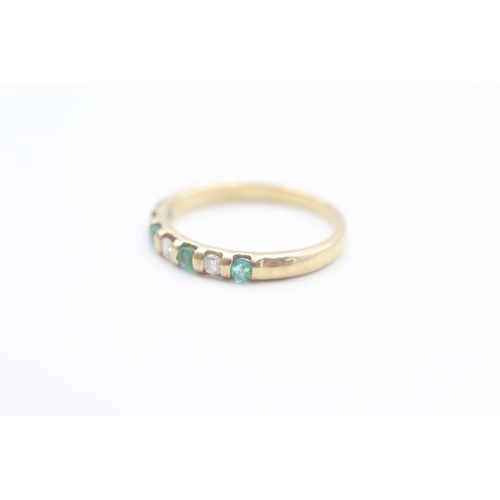 86 - 9ct gold diamond and emerald set seven stone eternity ring (1.6g) Size  L