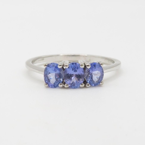 54 - 9ct gold tanzanite three stone ring (2.2g) Size  R 1/2