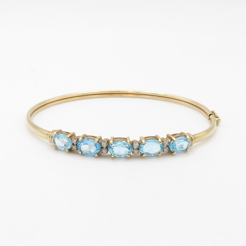 16 - 9ct gold diamond & topaz five stone bangle (6.8g)