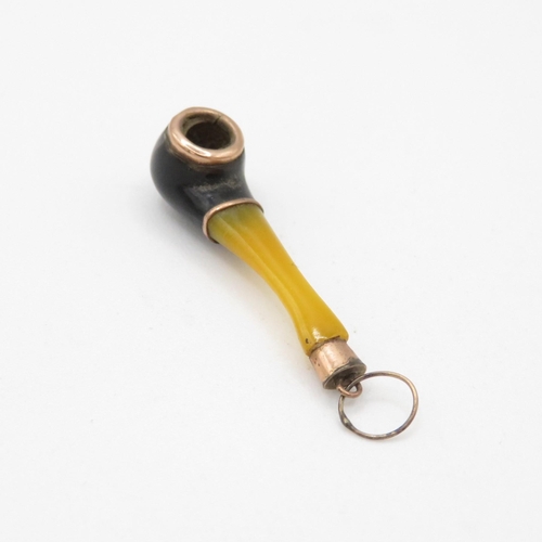 33 - 8ct gold and plastic pipe pendant (0.7g)